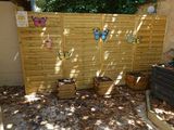 a wooden fence that has a bunch of items on it