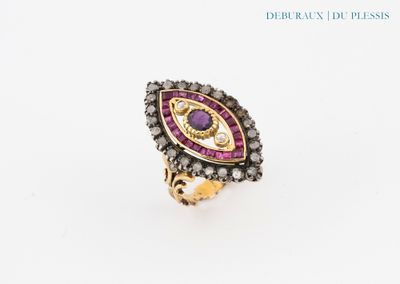 a close up of a ring with a purple stone in it
