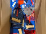 a cardboard box filled with different types of paint and brushes