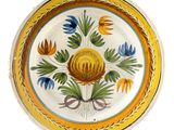 an image of a yellow and blue plate with flowers on it