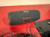 a black speaker sitting on top of a red box