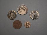 four coins are shown on a gray surface with a coin in the foreground