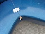 a blue curved bench with a tag on it