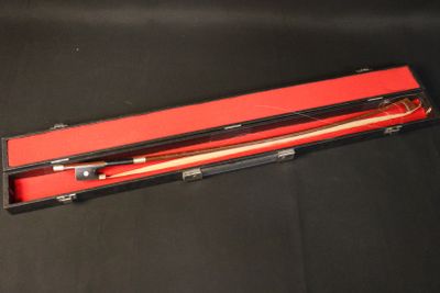 a red box with two wooden sticks in it