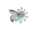 a close up of a flower brooch with blue and white stones