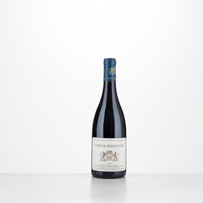 a bottle of red wine sitting on top of a table