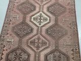 a brown and white rug on a white table