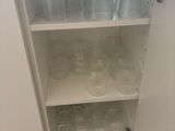 a cabinet with a lot of empty glasses on it
