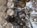 a box full of silver spoons and utensils on a table