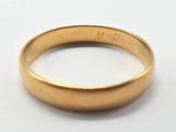 a close up of a gold ring on a white surface