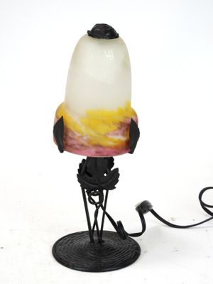 a lamp that is sitting on a stand on a white surface