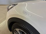 a close up of a white car with a sticker on it