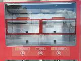 a red vending machine with a sign on it