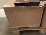 a cardboard box on top of a pallet in a room