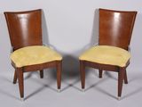 pair of mid century style chairs with yellow upholstered cushions
