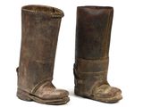 pair of old leather boots on a white surface with a white background