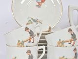 four cups and saucers with pictures of children on them