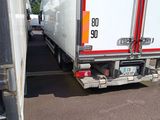 two trucks that are parked next to each other in a parking lot