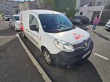a white van parked in a parking lot next to a building
