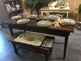 a wooden table with plates and silverware on it