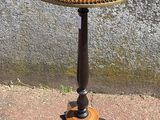 a small table with a wooden top on a sidewalk