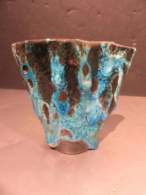 a blue and brown bowl sitting on a table