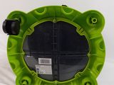 a close up of a green plastic plate with wheels on a white surface