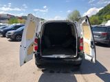 a white van with its doors open in a parking lot