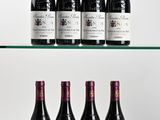 several bottles of wine sit on a glass shelf in front of a white background