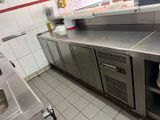 une cuisine avec des plans de travail en inox et un évier