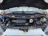the front end of a white car with its hood open