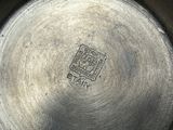a silver plate with a picture of a person on it