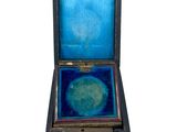 a small wooden box with a blue lid on it
