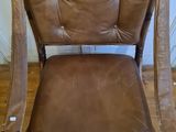 brown leather chair with metal legs and back rest