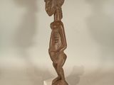 an image of a statue of a person standing on a white base