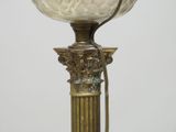 a lamp that has a glass shade on top of it