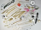 many different types of necklaces and bracelets on the table