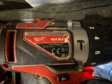a red and black drill that is sitting on a table