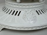 a large white vase with a decorative design on it