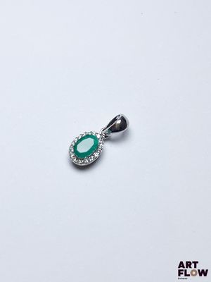 une image représentant un pendentif orné d'une pierre verte entourée de diamants