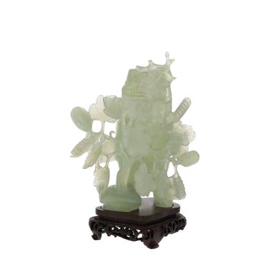 a statue of a man holding a fish on a stand