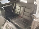 a picture of a black leather car seat in the back of a car