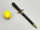 a knife and a lemon on a white surface