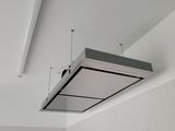 ceiling mounted exhaust hood in a white tiled bathroom with white tile walls