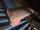 a rusted metal object sitting on top of a metal floor