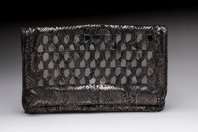 an image of a black and silver purse on a white surface