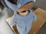 a doll that is wearing a blue shirt and a hat