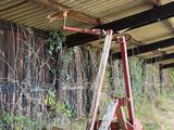 a red ladder that is leaning against the side of a building