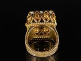 a close up of a gold ring on a black surface