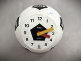 a white clock with a yellow and red arrow on it